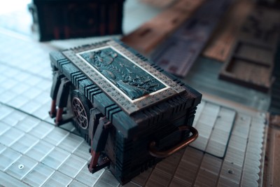 A finished sea chest puzzle box sits on the CNC table, ready for adventure on the high seas